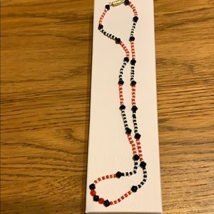 18” Necklace black, white, and orange beads.
